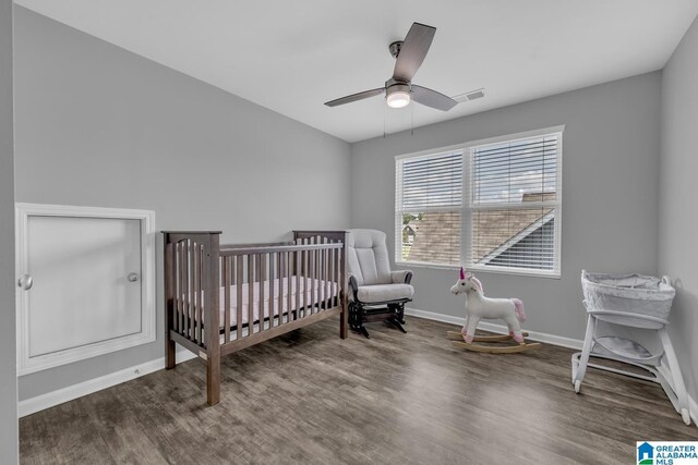 1515 Baxter Ave, Springville, AL 35146 - bedroom featuring wood finished floors, a nursery area, baseboards, and a ceiling fan