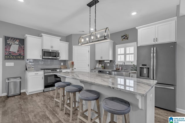 1515 Baxter Ave, Springville, AL 35146 - kitchen featuring appliances with stainless steel finishes, a sink, white cabinets, backsplash, and recessed lighting