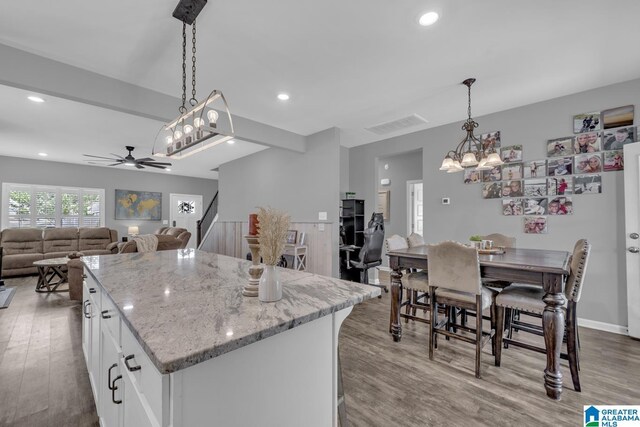 1515 Baxter Ave, Springville, AL 35146 - kitchen with a ceiling fan, wood finished floors, white cabinets, a center island, and recessed lighting
