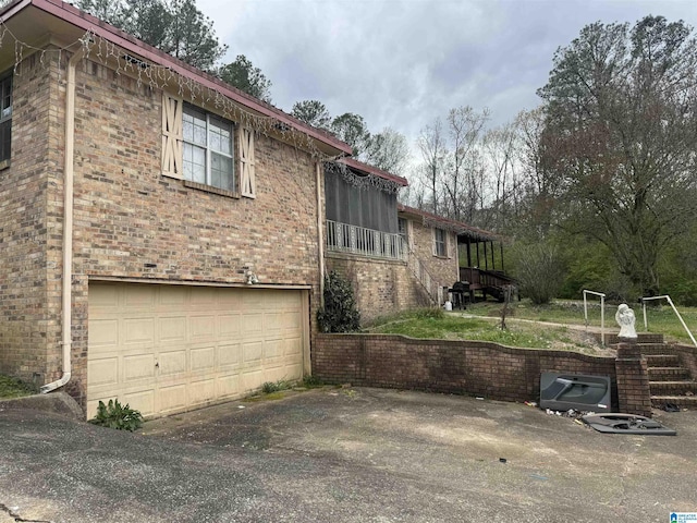 1001 26th St, Jasper, AL 35501 - view of property exterior with an attached garage, brick siding, and driveway