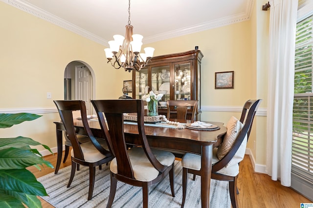 1963 Russet Hill Ln, Hoover, AL 35244 - dining room featuring arched walkways, a chandelier, ornamental molding, and light wood finished floors