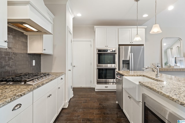3024 Camellia Ridge Ct, Pelham, AL 35124 - kitchen with custom exhaust hood, stainless steel appliances, dark wood-style flooring, pendant lighting, and white cabinets