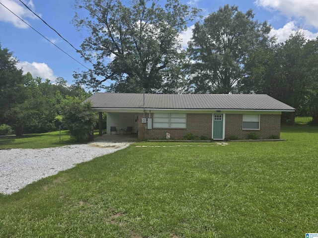 14187 Al Highway 22, Rockford, AL 35136 - single story home featuring a front yard, gravel driveway, brick siding, a carport, and metal roof