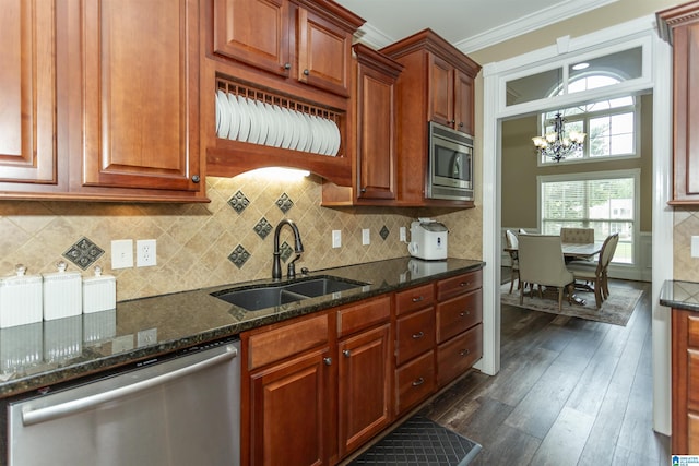295 Homestead Dr, Cropwell, AL 35054 - kitchen with appliances with stainless steel finishes, a chandelier, ornamental molding, dark stone countertops, and dark wood-style flooring