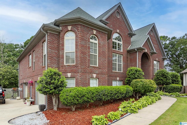 295 Homestead Dr, Cropwell, AL 35054 - view of front facade with brick siding, concrete driveway, an attached garage, and roof with shingles