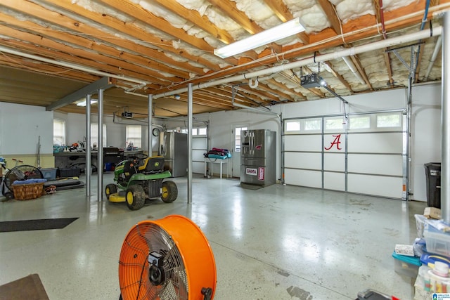 295 Homestead Dr, Cropwell, AL 35054 - garage featuring stainless steel refrigerator with ice dispenser and a garage door opener