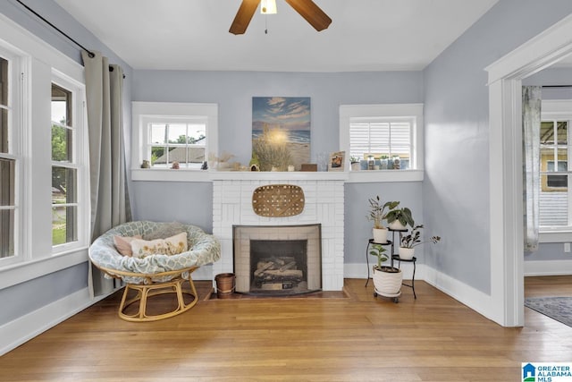 1138 14th Ave S, Birmingham, AL 35205 - living area featuring ceiling fan, wood finished floors, a fireplace, and baseboards
