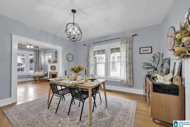 1138 14th Ave S, Birmingham, AL 35205 - dining room featuring a chandelier, light wood finished floors, baseboards, and a fireplace