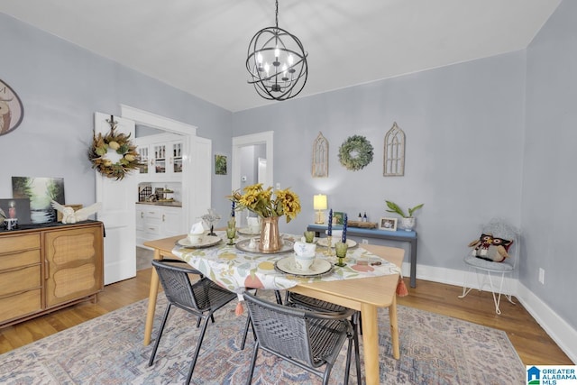 1138 14th Ave S, Birmingham, AL 35205 - dining area with a chandelier, wood finished floors, and baseboards