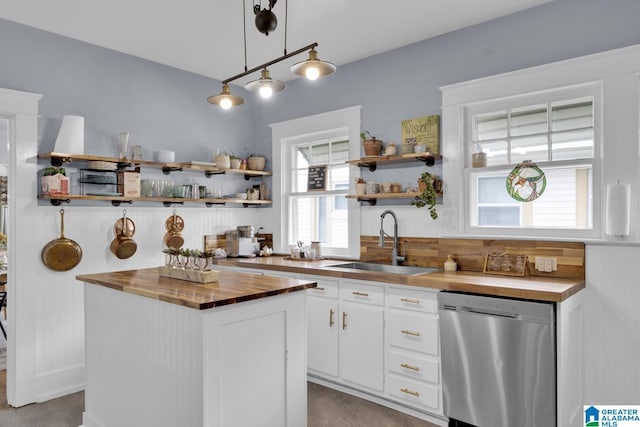 1138 14th Ave S, Birmingham, AL 35205 - kitchen with butcher block counters, stainless steel dishwasher, a sink, open shelves, and white cabinetry
