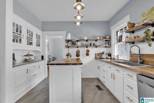 1138 14th Ave S, Birmingham, AL 35205 - kitchen with butcher block counters, open shelves, a sink, dishwasher, and white cabinetry