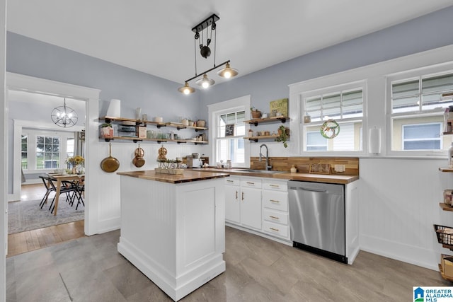 1138 14th Ave S, Birmingham, AL 35205 - kitchen featuring stainless steel dishwasher, wood counters, open shelves, a sink, and white cabinets