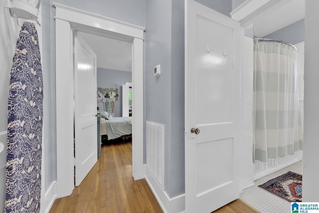 1138 14th Ave S, Birmingham, AL 35205 - bathroom featuring wood finished floors, ensuite bathroom, and a shower with shower curtain