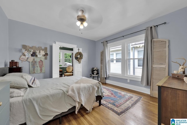 1138 14th Ave S, Birmingham, AL 35205 - bedroom with wood finished floors, baseboards, and ceiling fan