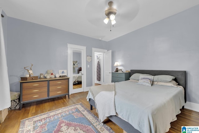1138 14th Ave S, Birmingham, AL 35205 - bedroom with wood finished floors, ceiling fan, and baseboards
