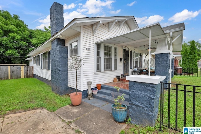 1138 14th Ave S, Birmingham, AL 35205 - manufactured / mobile home featuring a ceiling fan, a chimney, and a porch