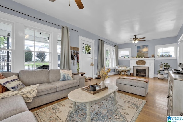 1138 14th Ave S, Birmingham, AL 35205 - living room featuring ceiling fan, light wood finished floors, and a brick fireplace