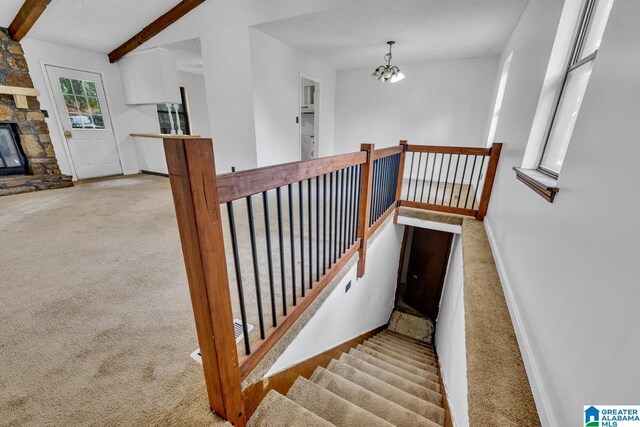 1117 Oak Creek Trl NE, Pinson, AL 35215 - staircase with carpet, a chandelier, a fireplace, and beam ceiling