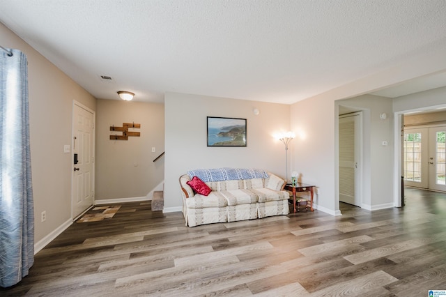 1529 Applegate Ln, Alabaster, AL 35007 - living area with wood finished floors, stairway, baseboards, and a textured ceiling