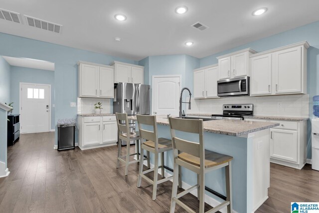 1009 Canvasback Way, Alabaster, AL 35007 - kitchen featuring stainless steel appliances, tasteful backsplash, dark wood finished floors, white cabinetry, and recessed lighting