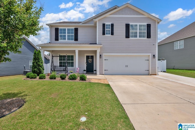 1009 Canvasback Way, Alabaster, AL 35007 - traditional-style house featuring covered porch, an attached garage, driveway, and a front lawn