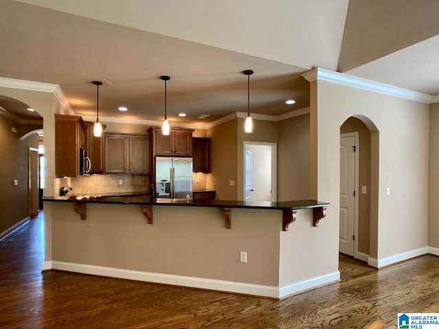 168 Willow View Ln, Westover, AL 35186 - kitchen featuring stainless steel appliances, arched walkways, dark wood-type flooring, a peninsula, and ornamental molding