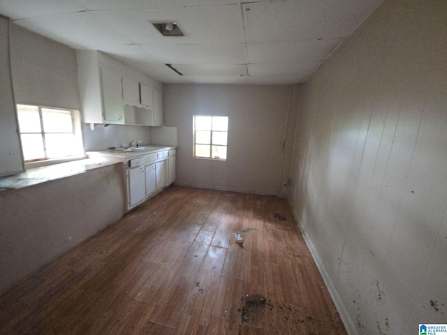 1414 27th St, Birmingham, AL 35218 - kitchen featuring light wood finished floors, white cabinetry, and light countertops