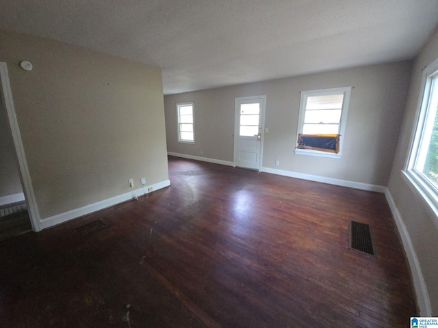 1414 27th St, Birmingham, AL 35218 - unfurnished living room featuring dark wood finished floors and baseboards