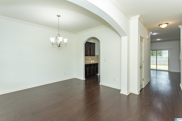 319 Glen Cross Way, Trussville, AL 35173 - unfurnished living room featuring ornamental molding, dark wood-type flooring, a chandelier, and arched walkways