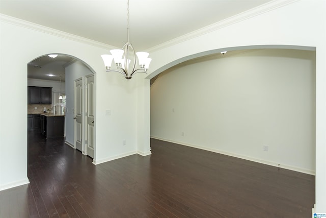 319 Glen Cross Way, Trussville, AL 35173 - unfurnished room with arched walkways, a chandelier, dark wood-style flooring, and crown molding
