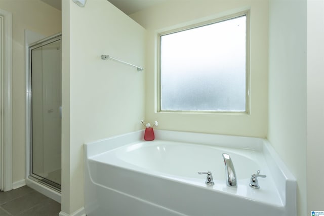 319 Glen Cross Way, Trussville, AL 35173 - bathroom featuring healthy amount of natural light, a garden tub, a stall shower, and tile patterned flooring