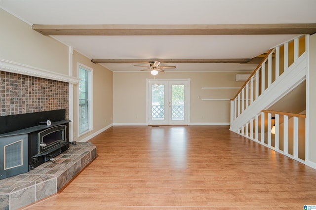 840 Black Acres Rd, Cropwell, AL 35054 - unfurnished living room with beamed ceiling, light wood-type flooring, plenty of natural light, and a wood stove