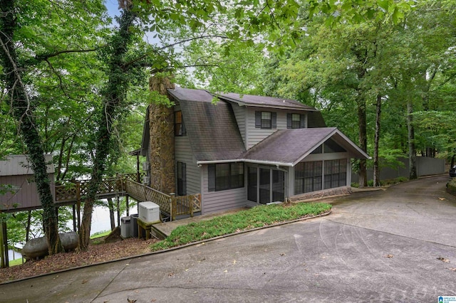 840 Black Acres Rd, Cropwell, AL 35054 - dutch colonial featuring a sunroom, roof with shingles, a chimney, driveway, and a wooden deck