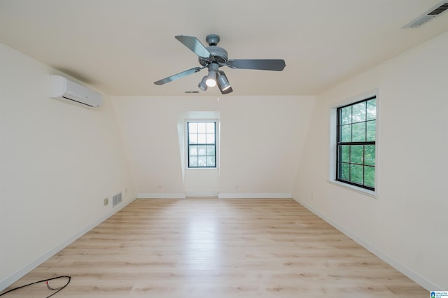 840 Black Acres Rd, Cropwell, AL 35054 - unfurnished room with a wall mounted AC, plenty of natural light, light wood-type flooring, and a ceiling fan