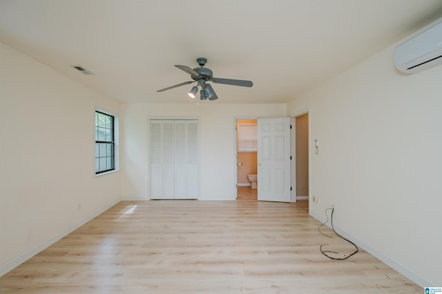 840 Black Acres Rd, Cropwell, AL 35054 - unfurnished bedroom featuring an AC wall unit, light wood-style flooring, a closet, and a ceiling fan