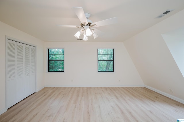 840 Black Acres Rd, Cropwell, AL 35054 - unfurnished bedroom with multiple windows, light wood-type flooring, a closet, and a ceiling fan