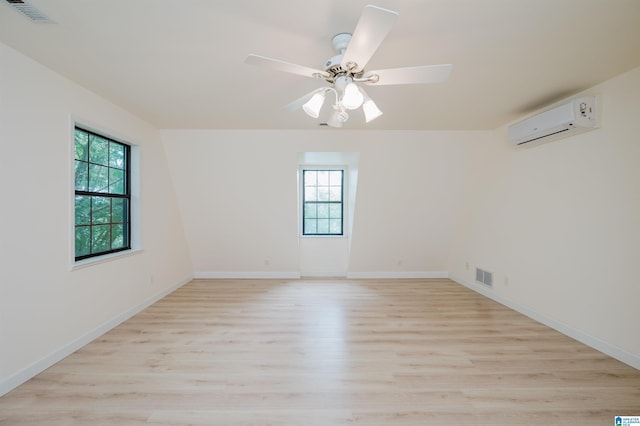 840 Black Acres Rd, Cropwell, AL 35054 - unfurnished room with a wall unit AC, plenty of natural light, light wood-style floors, and ceiling fan