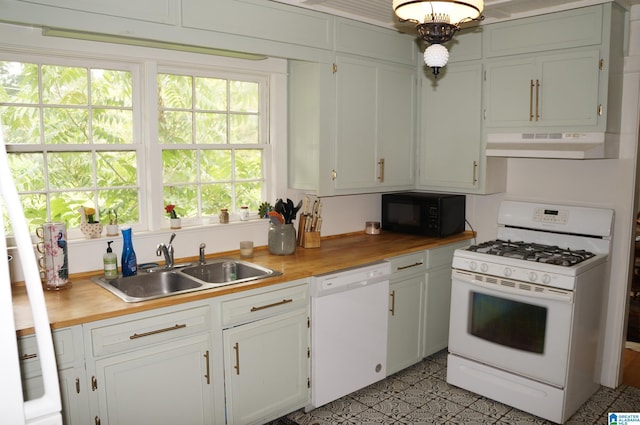 702 4th St SW, Childersburg, AL 35044 - kitchen featuring white appliances, under cabinet range hood, wood counters, and white cabinetry