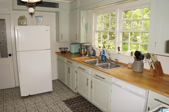 702 4th St SW, Childersburg, AL 35044 - kitchen featuring white appliances, butcher block countertops, healthy amount of natural light, and white cabinets