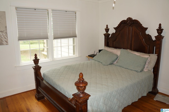 702 4th St SW, Childersburg, AL 35044 - bedroom with wood finished floors and baseboards