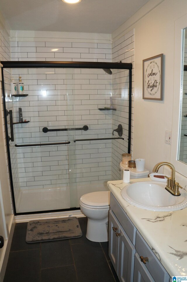 702 4th St SW, Childersburg, AL 35044 - full bath featuring vanity, a stall shower, and tile patterned floors