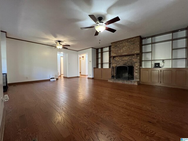 404 9th Ave NE, Jacksonville, AL 36265 - unfurnished living room featuring a ceiling fan, wood finished floors, built in shelves, a brick fireplace, and ornamental molding