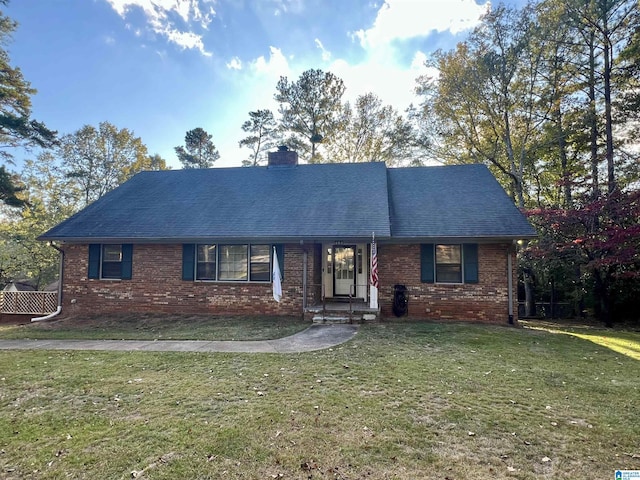 404 9th Ave NE, Jacksonville, AL 36265 - view of front of house with brick siding, a chimney, a front lawn, and a shingled roof