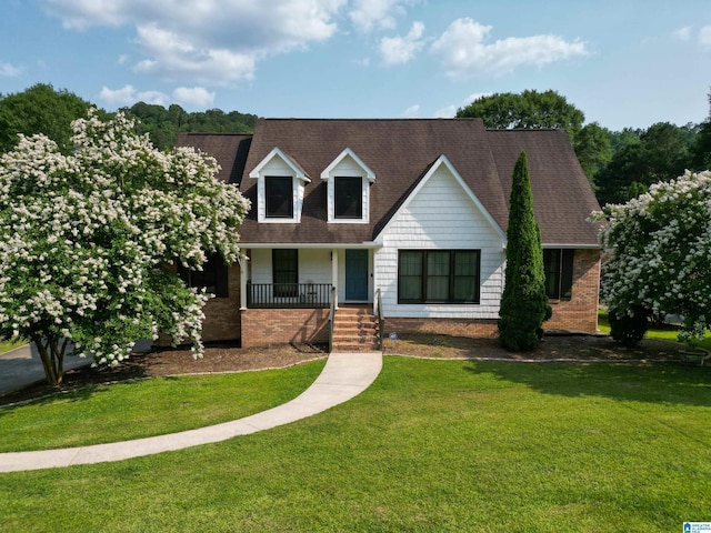 7835 Windsong Dr, Trussville, AL 35173 - new england style home with roof with shingles, a front lawn, and a porch