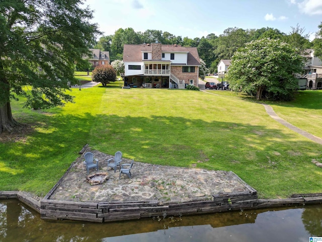 7835 Windsong Dr, Trussville, AL 35173 - back of house with a deck with water view, an outdoor fire pit, stairs, and a lawn