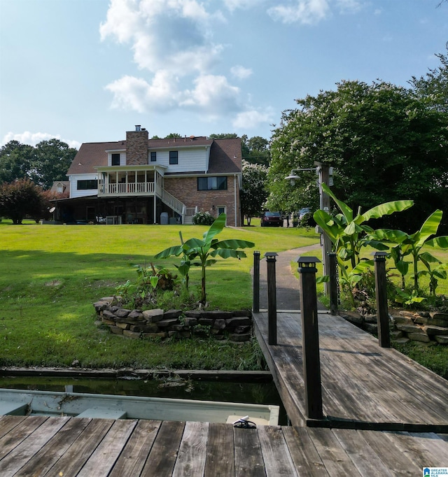 7835 Windsong Dr, Trussville, AL 35173 - back of property featuring stairs, a lawn, a wooden deck, and brick siding