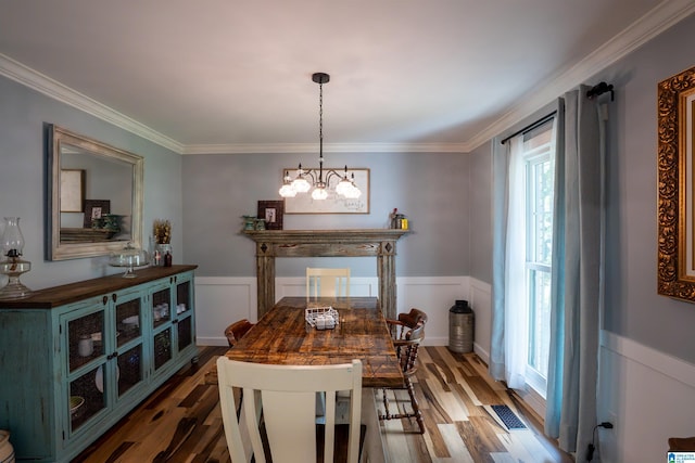 7835 Windsong Dr, Trussville, AL 35173 - dining area with wood finished floors, ornamental molding, a wainscoted wall, a chandelier, and a decorative wall