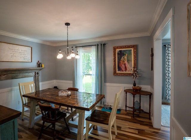7835 Windsong Dr, Trussville, AL 35173 - dining area with wood finished floors, crown molding, a chandelier, wainscoting, and a decorative wall