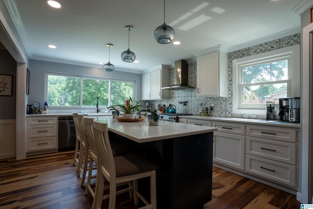 7835 Windsong Dr, Trussville, AL 35173 - kitchen featuring wall chimney range hood, dishwashing machine, ornamental molding, white cabinets, and decorative backsplash