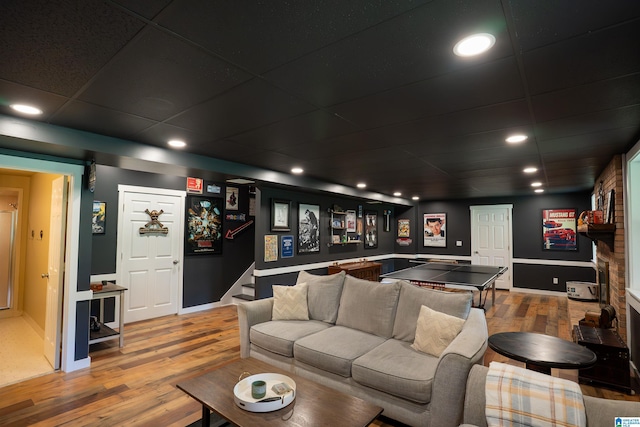 7835 Windsong Dr, Trussville, AL 35173 - living room with wood finished floors, a paneled ceiling, stairway, recessed lighting, and a large fireplace